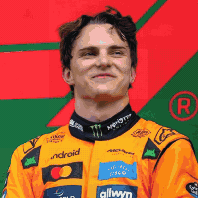 A Man Wearing An Orange Racing Suit With Monster Energy And Allwyn Logos GIF