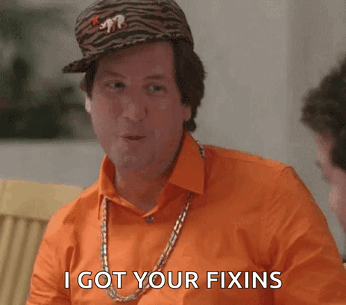 A Man Wearing An Orange Shirt And A Tiger Hat Says I Got Your Fixins GIF