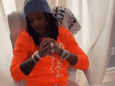 A Man Wearing An Orange Shirt That Says ' A.h. ' On It GIF