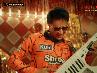 A Man Wearing An Orange Shirt That Says Kuhl On It GIF