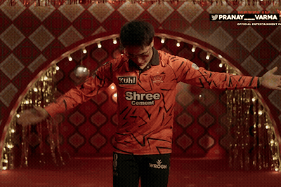 A Man Wearing An Orange Shirt That Says Kuhl Shree Central GIF