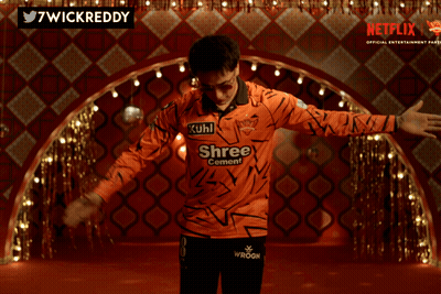 A Man Wearing An Orange Shirt That Says Kuhl Shree On It GIF