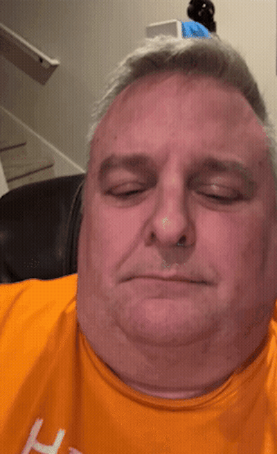 A Man Wearing An Orange Shirt With The Letter H On The Front GIF