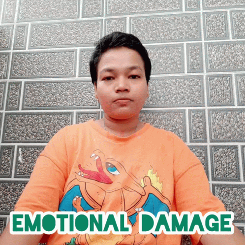 A Man Wearing An Orange Shirt With The Word Emotional Damage Written On It GIF