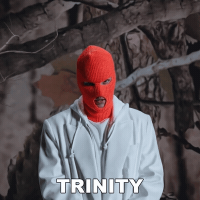 A Man Wearing An Orange Ski Mask And A White Jacket Says Trinity In White Letters GIF