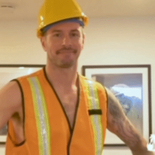 A Man Wearing An Orange Vest And Hard Hat GIF