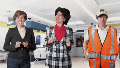 A Man Wearing An Orange Vest Has A Sticker On His Hat That Says ' Coca Cola ' On It GIF