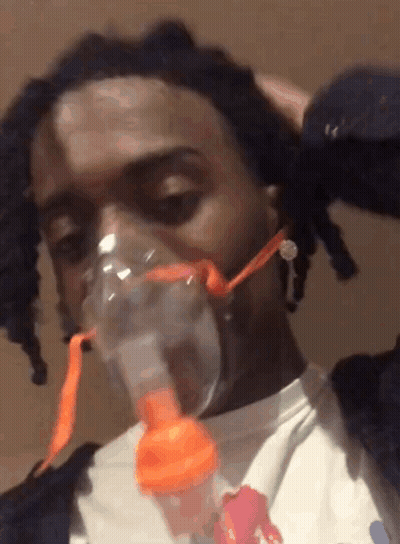 A Man Wearing An Oxygen Mask On His Face GIF