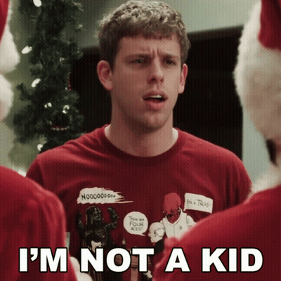 A Man Wearing An Ugly Christmas Sweater With The Words I 'M Not A Kid On The Bottom GIF