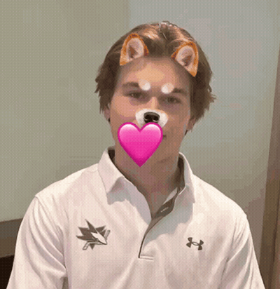 A Man Wearing An Under Armour Shirt Has A Heart In His Mouth GIF