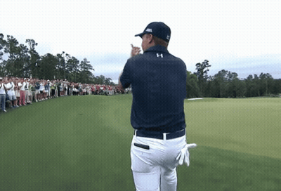 A Man Wearing An Under Armour Shirt Stands On A Golf Course In Front Of A Crowd GIF