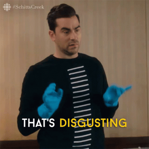 A Man Wearing Blue Gloves And A Shirt That Says Schitts Creek GIF