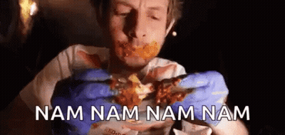A Man Wearing Blue Gloves Is Eating A Piece Of Meat With The Words Nam Nam Nam Nam Written Below Him . GIF