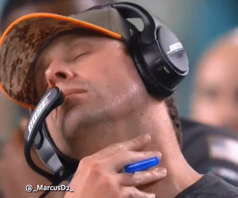 A Man Wearing Bose Headphones Holds A Blue Pen In His Hand GIF