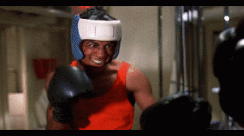 A Man Wearing Boxing Gloves And A Helmet That Says ' I ' On It GIF