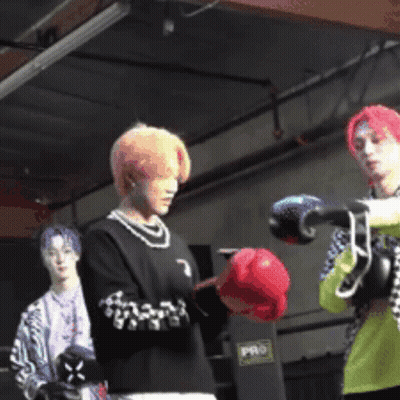 A Man Wearing Boxing Gloves Stands In A Boxing Ring GIF