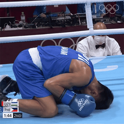 A Man Wearing Boxing Gloves That Say Tokyo 2020 On Them GIF