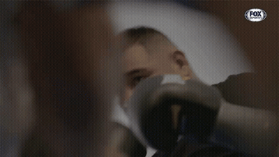 A Man Wearing Boxing Gloves With A Fox Sports Logo GIF