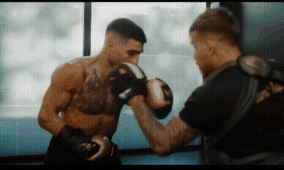 A Man Wearing Boxing Gloves With The Letter R On Them GIF