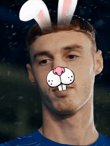 A Man Wearing Bunny Ears On His Head Looks At The Camera GIF