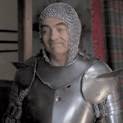 A Man Wearing Chain Mail And Armor Is Smiling GIF