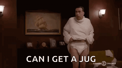 A Man Wearing Diapers And A Sweater Is Standing In A Living Room With The Words `` Can I Get A Jug '' . GIF