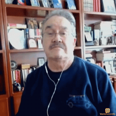 A Man Wearing Ear Buds And A Blue Shirt With A Car On It GIF