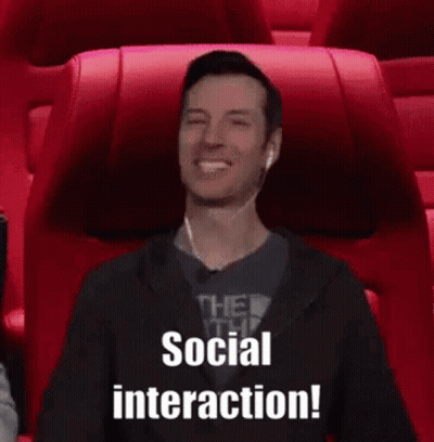 A Man Wearing Ear Buds Is Sitting In A Movie Theater And Says Social Interaction . GIF