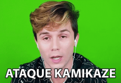 A Man Wearing Ear Buds Says " Ataque Kamikaze " In Front Of A Green Screen GIF