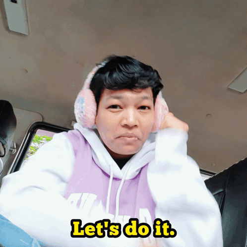 A Man Wearing Ear Muffs And A Hoodie That Says Let 'S Do It On It GIF