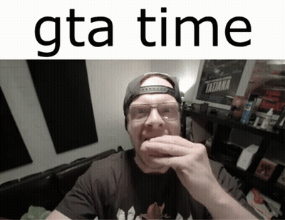 A Man Wearing Glasses And A Baseball Cap Is Eating A Hamburger With The Words Gta Time Above Him GIF