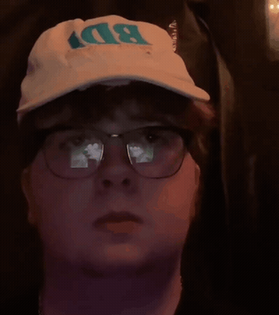 A Man Wearing Glasses And A Bd Hat GIF
