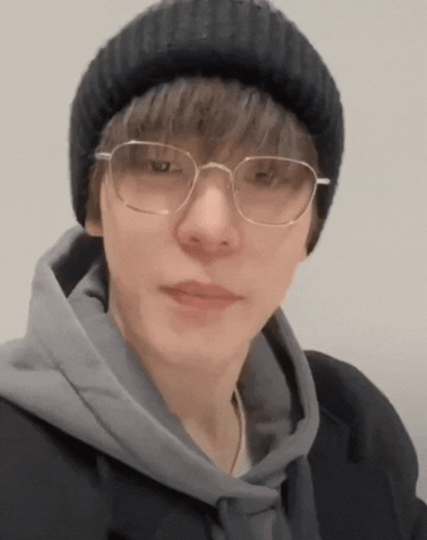 Man In Glasses And Beanie Looking At Camera GIF