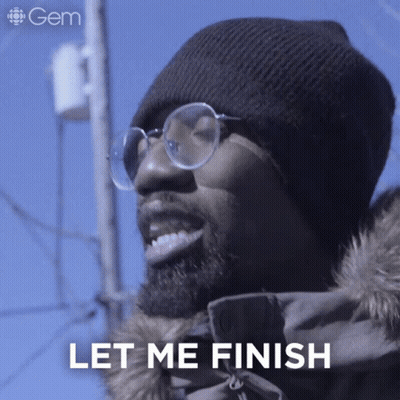 A Man Wearing Glasses And A Beanie Is Smiling And Says Let Me Finish GIF