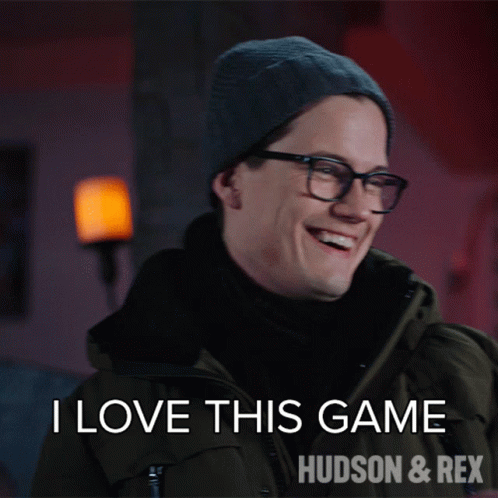 A Man Wearing Glasses And A Beanie Says I Love This Game Hudson And Rex GIF