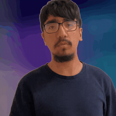 A Man Wearing Glasses And A Beard Is Making A Funny Face GIF