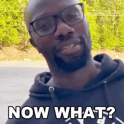 A Man Wearing Glasses And A Black Hoodie Is Asking " Now What " GIF