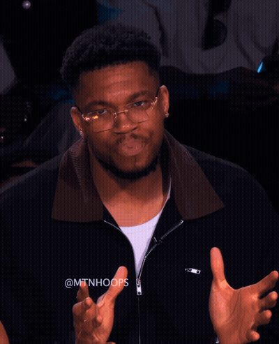 A Man Wearing Glasses And A Black Jacket With The Hashtag @Mtnhoops On It GIF