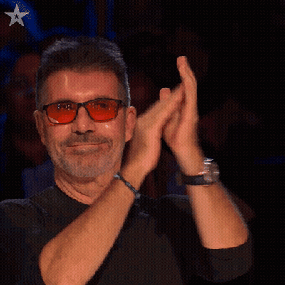 A Man Wearing Glasses And A Black Shirt Is Clapping GIF