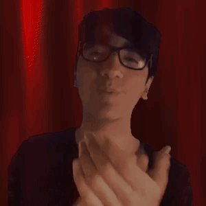 A Man Wearing Glasses And A Black Shirt Is Clapping His Hands GIF