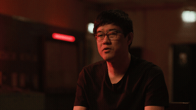 A Man Wearing Glasses And A Black Shirt Is Giving A Thumbs Up GIF