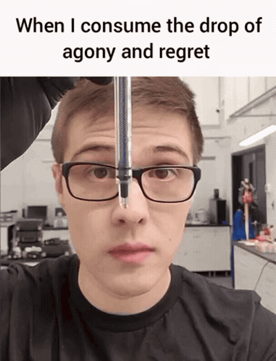 A Man Wearing Glasses And A Black Shirt Is Looking At A Drop Of Agony And Regret GIF