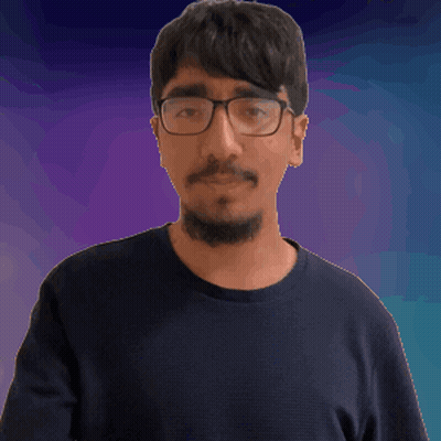 A Man Wearing Glasses And A Black Shirt Is Making A Fist GIF