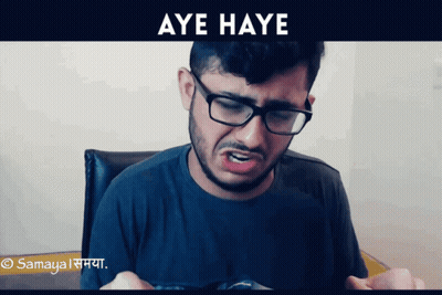 A Man Wearing Glasses And A Black Shirt Is Making A Funny Face And The Words Aye Haye Are Above Him GIF