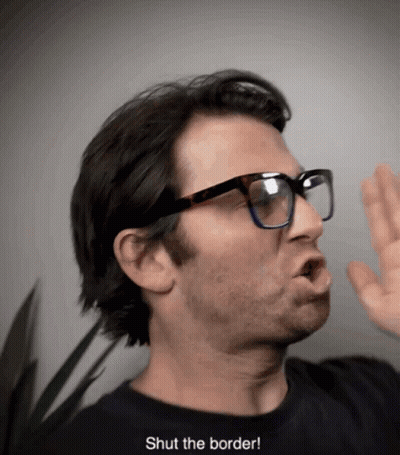 A Man Wearing Glasses And A Black Shirt Says " Shut The Border " GIF