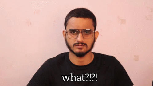 A Man Wearing Glasses And A Black Shirt Says What ?? GIF