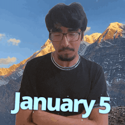 A Man Wearing Glasses And A Black Shirt Stands In Front Of A Mountain And The Date January 5 GIF