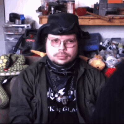 A Man Wearing Glasses And A Black Shirt That Says King On It GIF