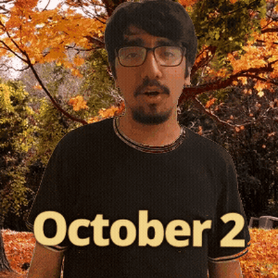 A Man Wearing Glasses And A Black Shirt That Says October 2 On It GIF
