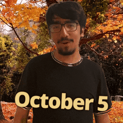 A Man Wearing Glasses And A Black Shirt That Says October 5 On It GIF